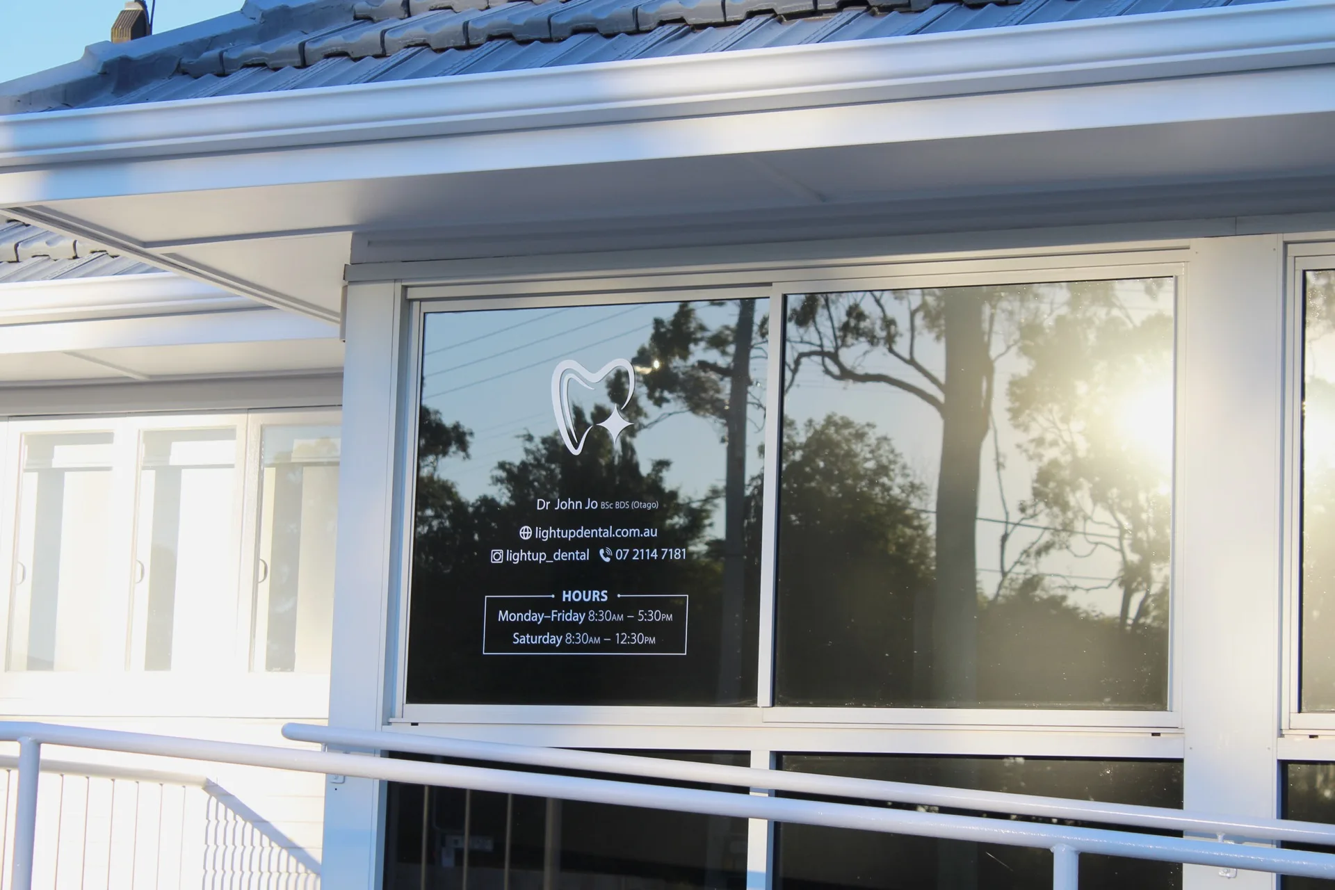 LightUP Dental signage on the front window with opening hours