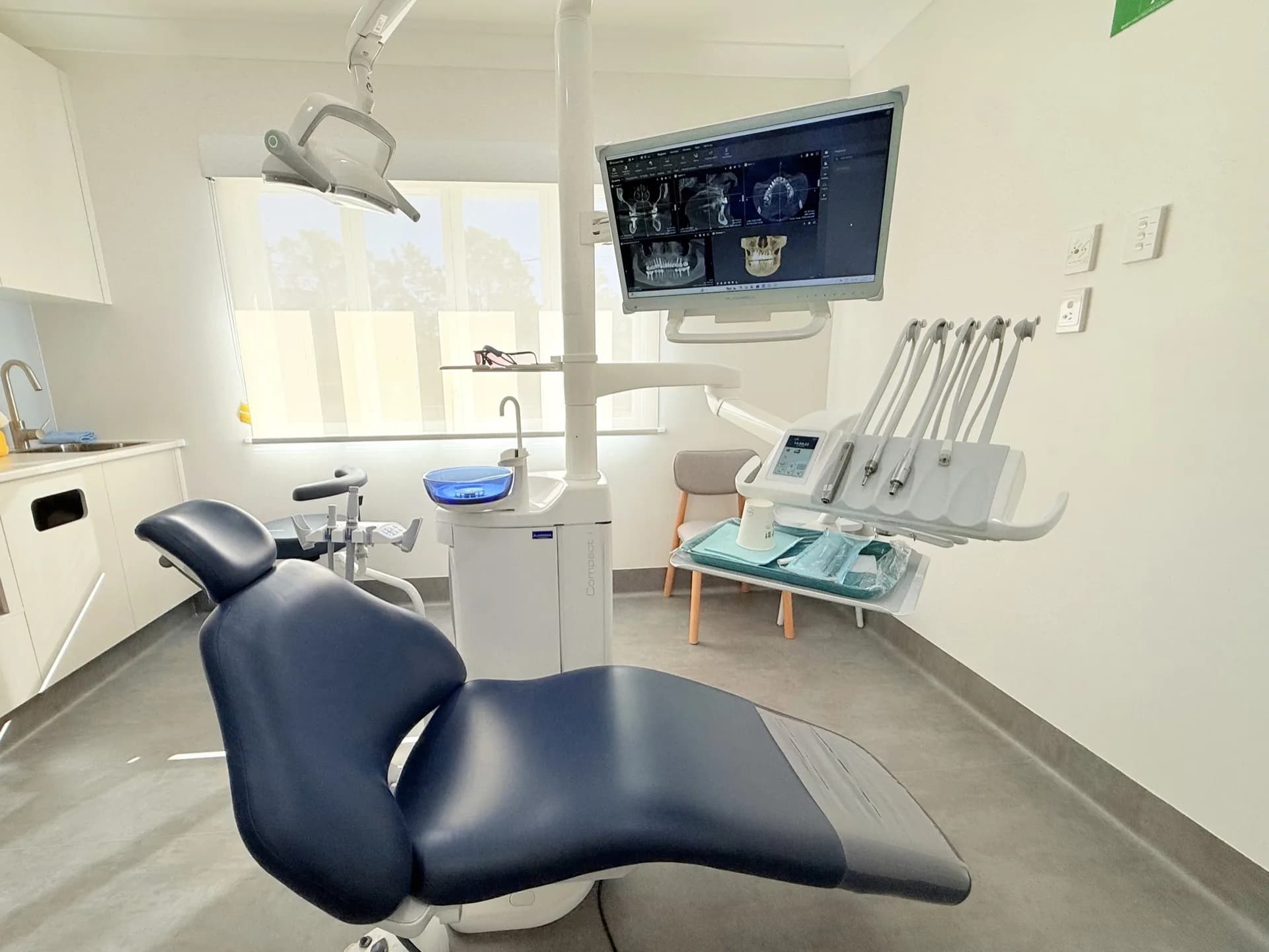 Treatment room with dental chair and digital X-ray monitor